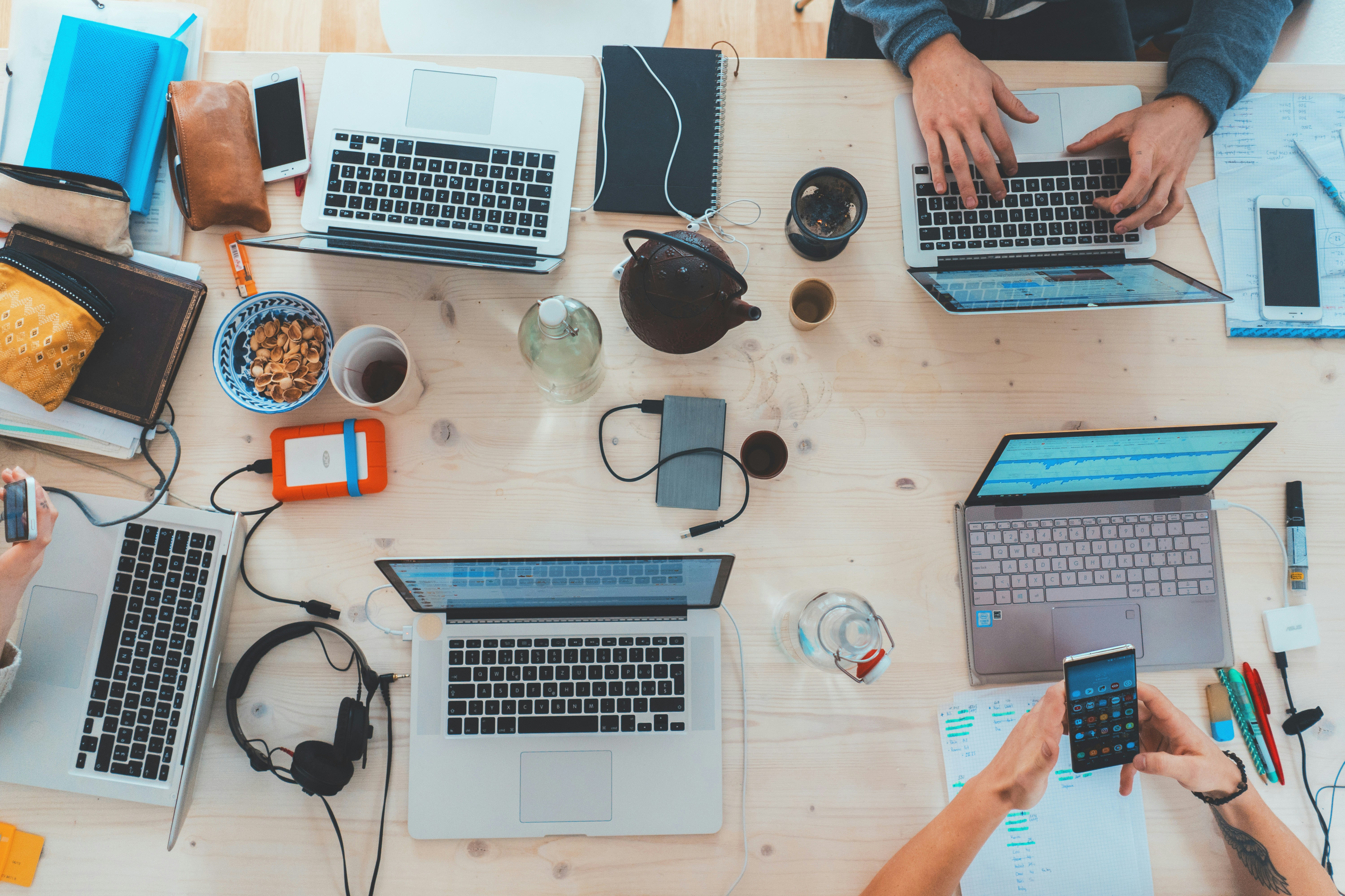 A workspace with multiple open laptops
